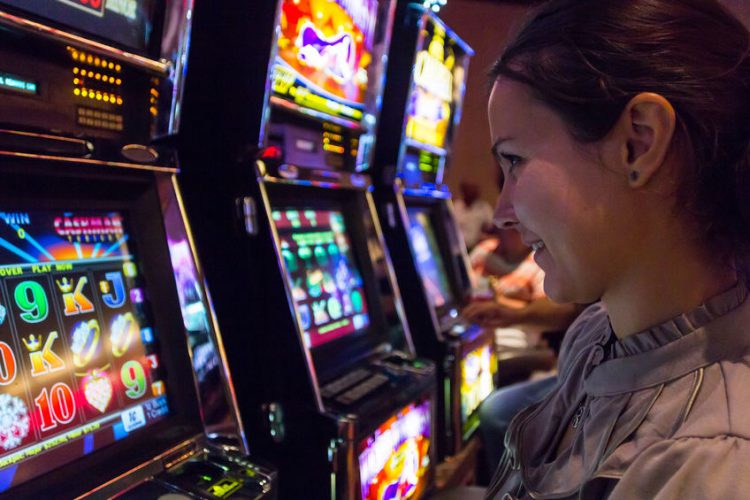 Find-best-paying-slots-feature-picture-lady-plays-slot machine-Las-Vegas